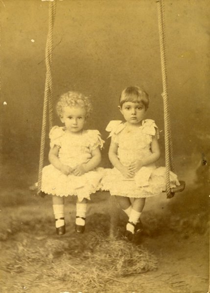 Untitled (studio portrait of two little girls on a swing)