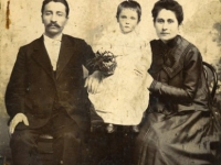 studio portrait of a husband and wife with their child