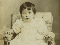 Studio portrait of a child in armchair