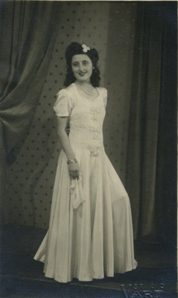 untitled (studio portrait of a bridesmaid with handkertchief and ribbons on her dress)