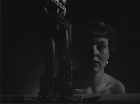 Untitled (model with a Tiki sculpture)